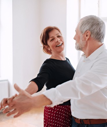 Expert Salsa and Bachata instructor teaching adult dance class in studio